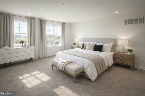 a spacious bedroom with a bed and a large window