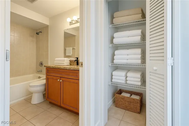 a bathroom with a toilet sink vanity and mirror