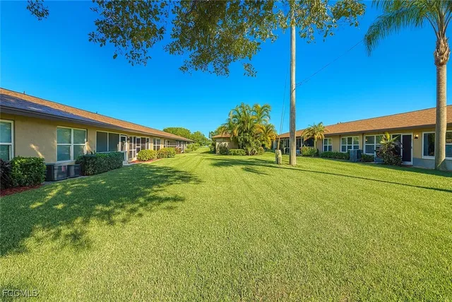 a view of an house with backyard space and balcony