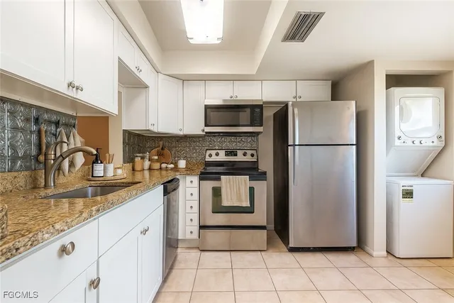 a kitchen with a refrigerator sink and microwave