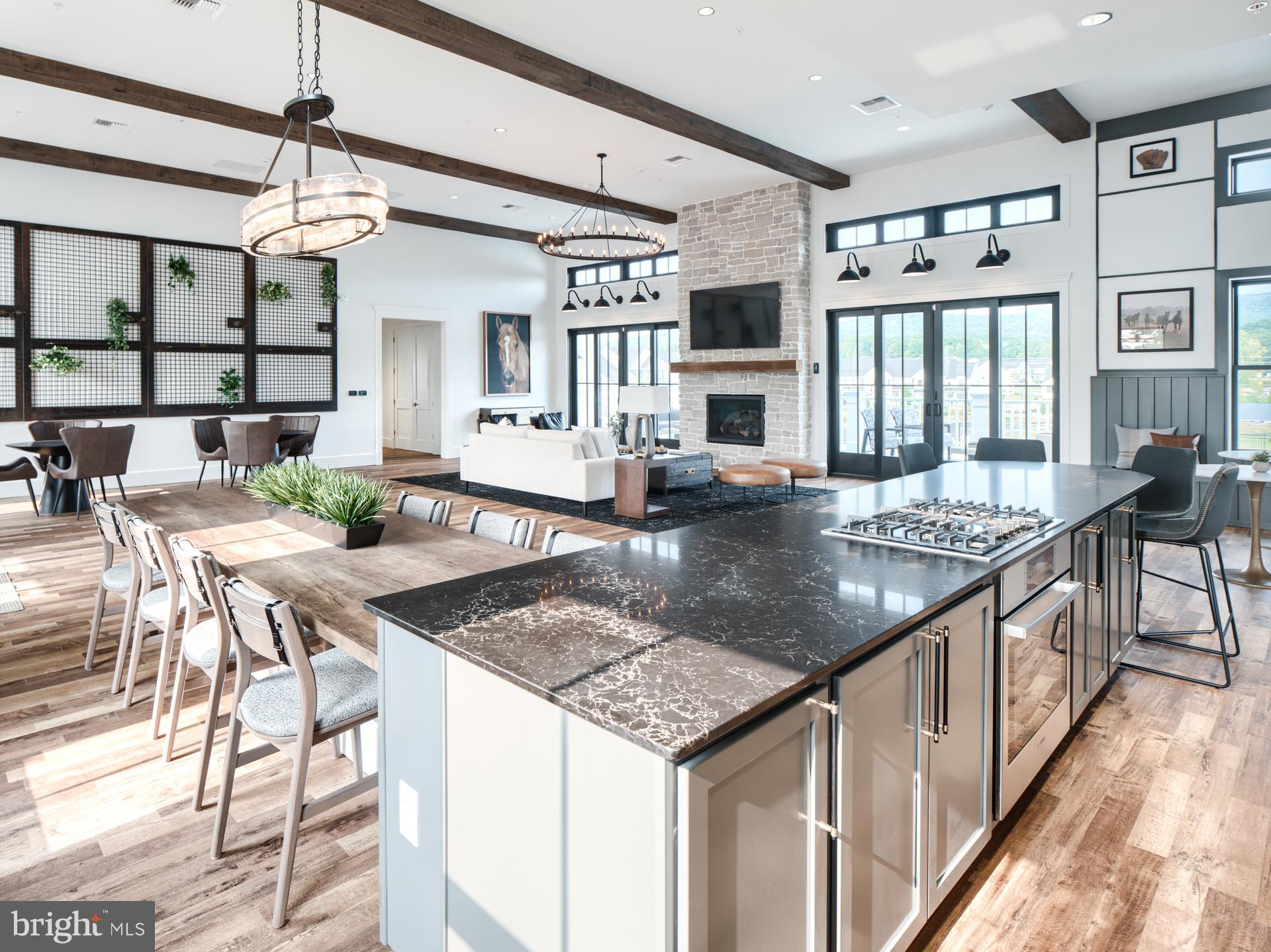2603 Front Shed Drive Frederick, MD 21702 - Photo 55 of 77 a kitchen with stainless steel appliances granite countertop a kitchen island a stove a table and chairs