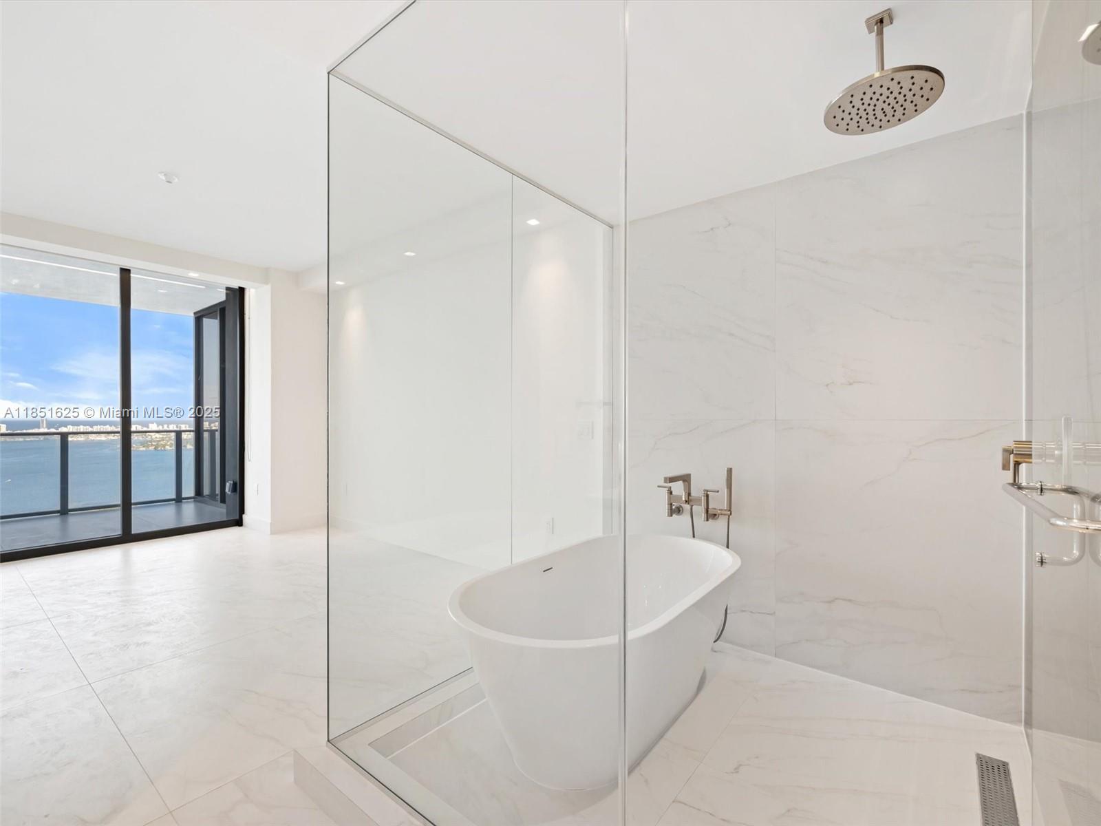 700 Northeast 24th Street, Unit 4305 Miami, FL 33137 - Photo 16 of 54 a bathroom with a bathtub and a shower