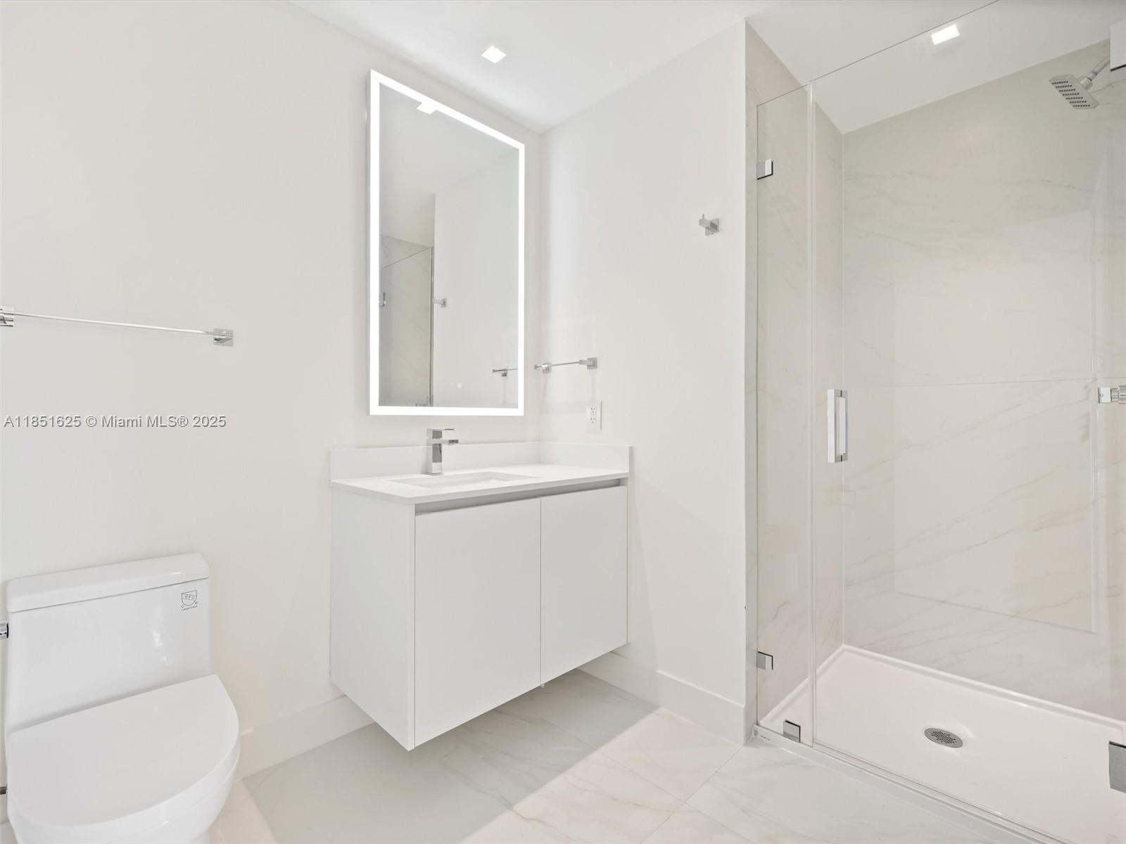 700 Northeast 24th Street, Unit 4305 Miami, FL 33137 - Photo 19 of 54 a bathroom with a sink a toilet and shower