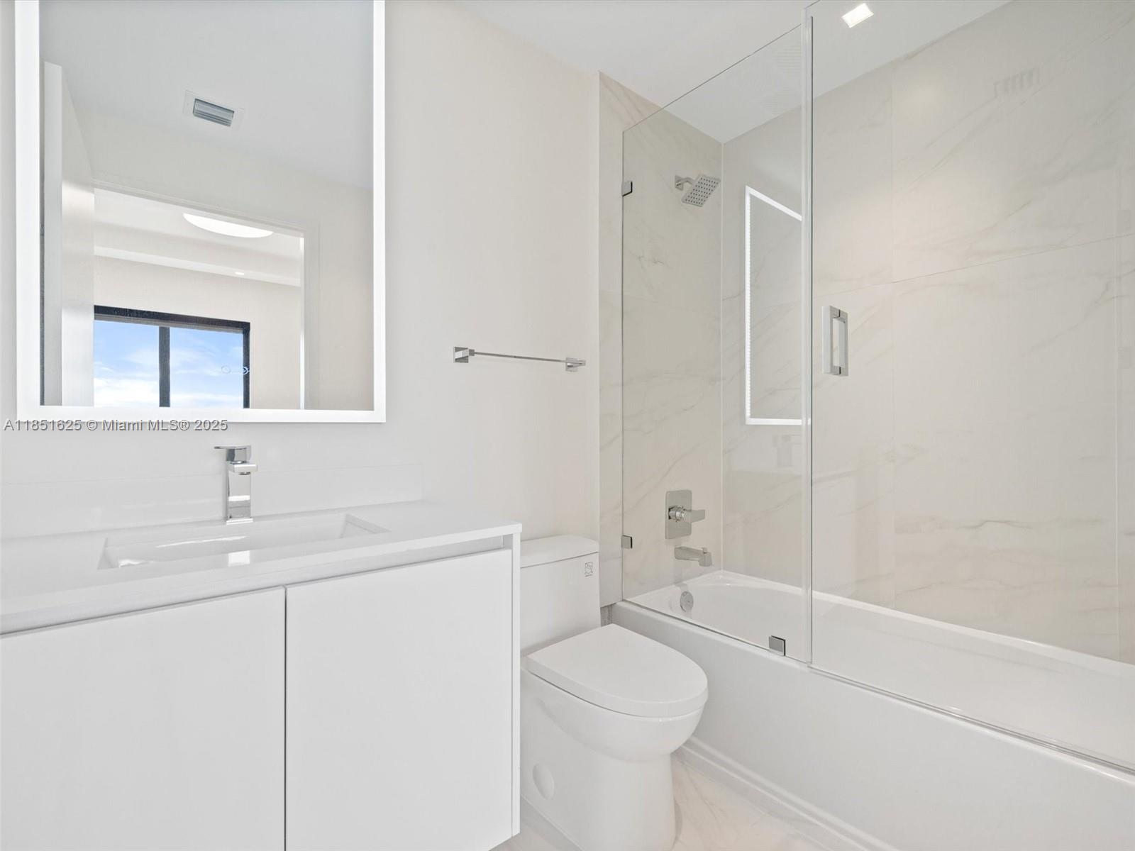 700 Northeast 24th Street, Unit 4305 Miami, FL 33137 - Photo 22 of 54 a bathroom with a sink a toilet and shower