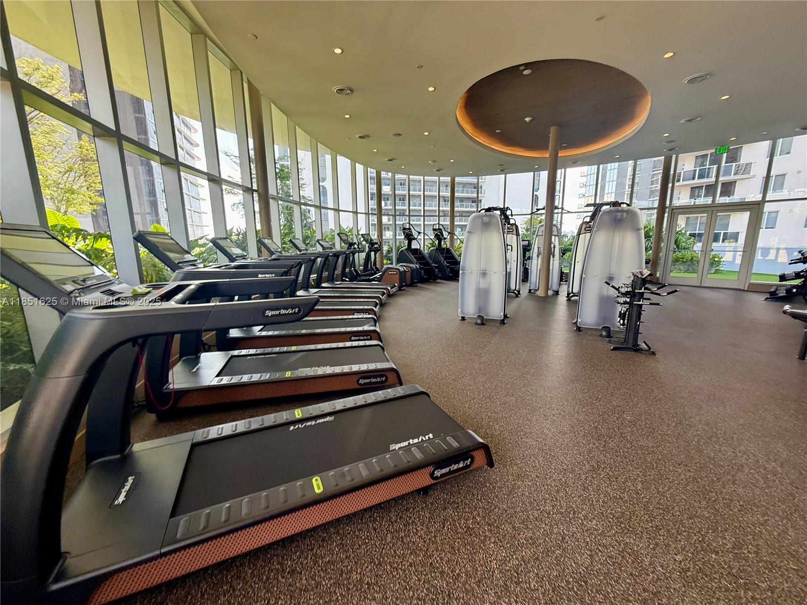 700 Northeast 24th Street, Unit 4305 Miami, FL 33137 - Photo 33 of 54 a room with gym equipment and a large window