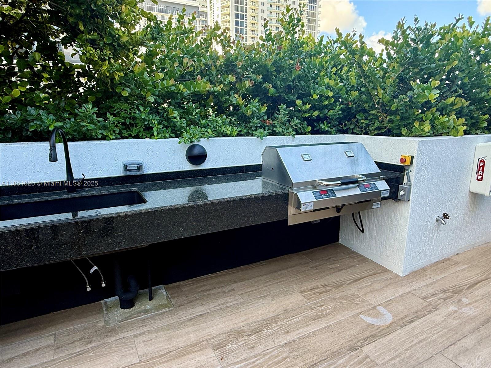 700 Northeast 24th Street, Unit 4305 Miami, FL 33137 - Photo 34 of 54 a backyard of a house with wooden floor and fence