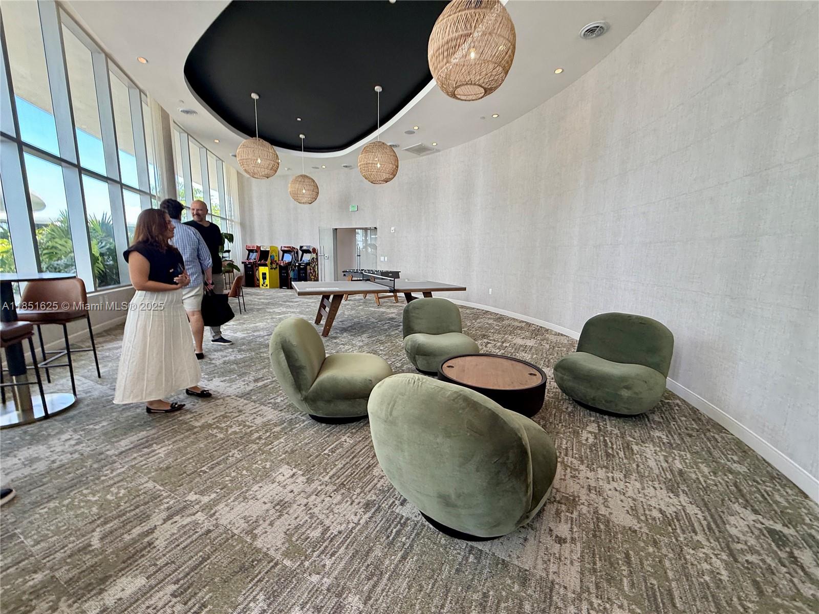 700 Northeast 24th Street, Unit 4305 Miami, FL 33137 - Photo 49 of 54 a living room with lots of furniture and mirrors