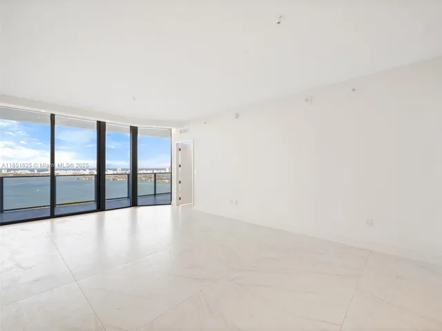 a view of an empty room with glass door