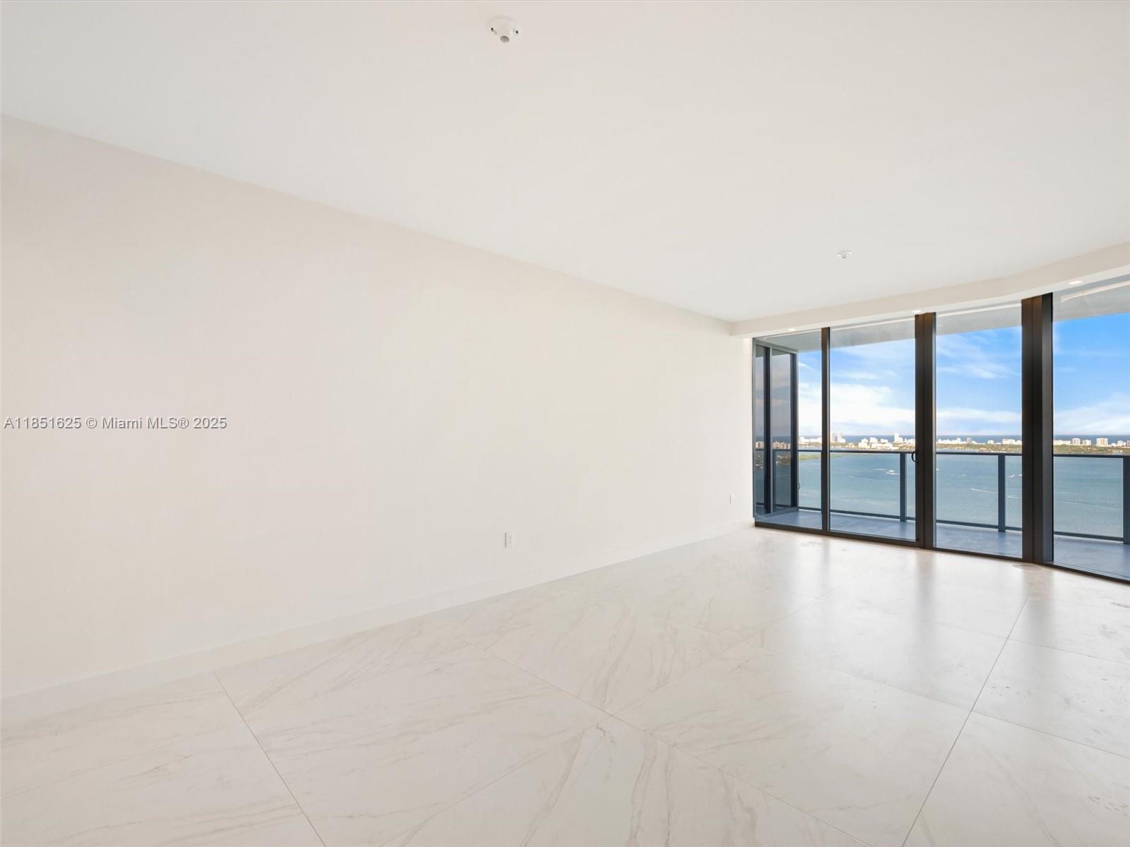 700 Northeast 24th Street, Unit 4305 Miami, FL 33137 - Photo 6 of 54 a view of an empty room with glass door