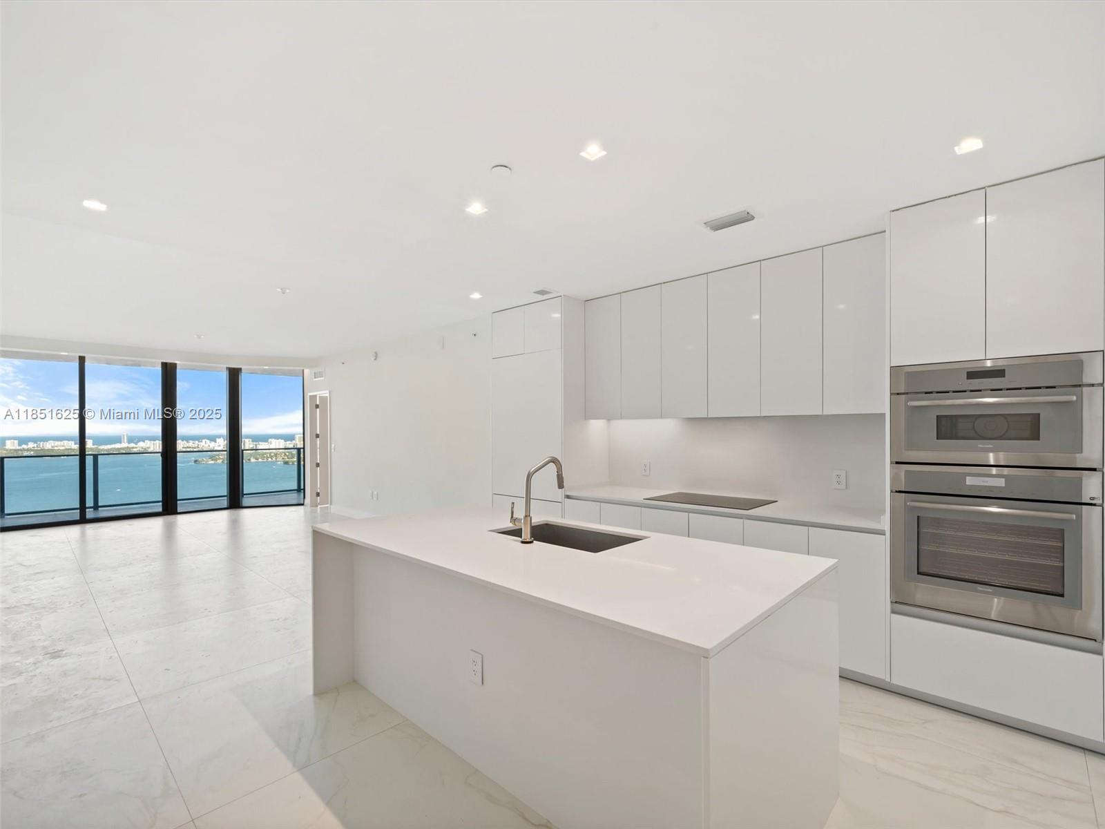 700 Northeast 24th Street, Unit 4305 Miami, FL 33137 - Photo 7 of 54 a kitchen with a sink and cabinets