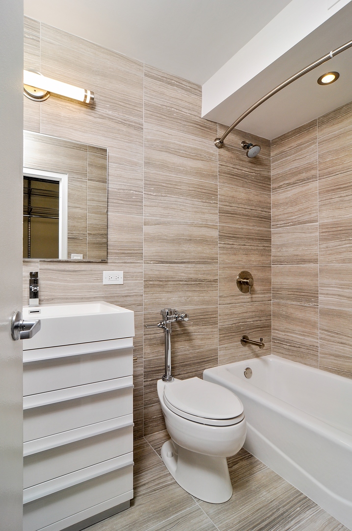 21 West Goethe Street, Unit 16K Chicago, IL 60610 - Photo 7 of 10 a bathroom with a toilet and a bathtub