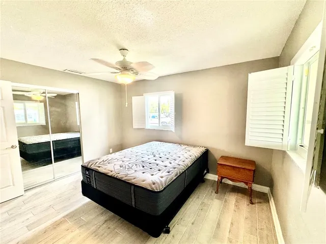 a bathroom with a granite countertop sink mirror vanity and toilet
