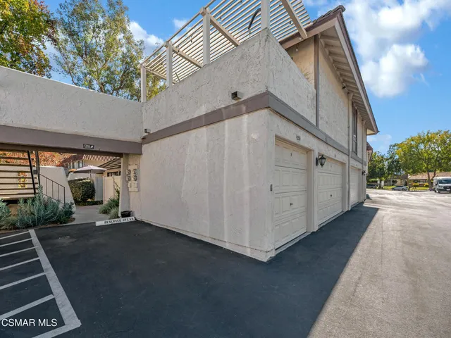 a backyard of a house with basket ball court