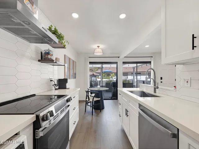 a kitchen with a sink stove and cabinets
