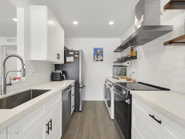 a kitchen with a sink a stove and cabinets