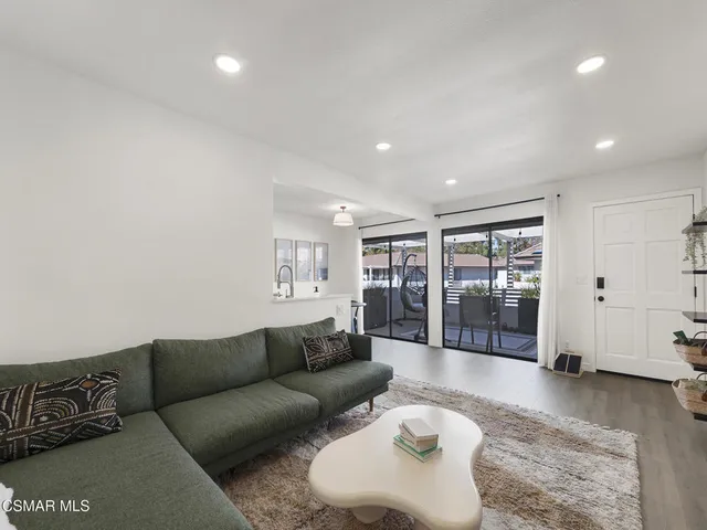 a living room with furniture and glass door