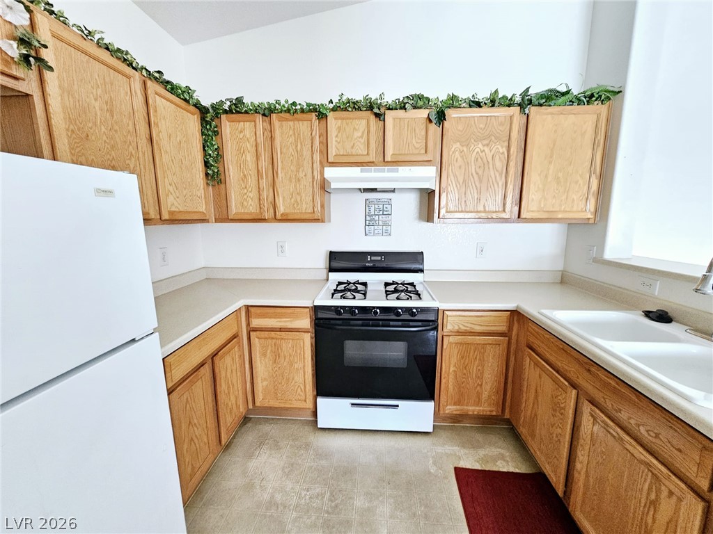 1663 Lefty Garcia Way Henderson, NV 89002 - Photo 16 of 31 A compact kitchen featuring ample cabinet space and essential appliances.