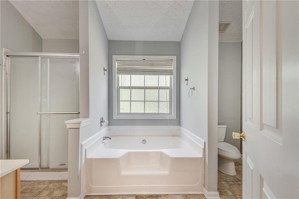 3337 Baymount Way Lawrenceville, GA 30043 - Photo 28 of 47 a bathroom with a bathtub and a toilet