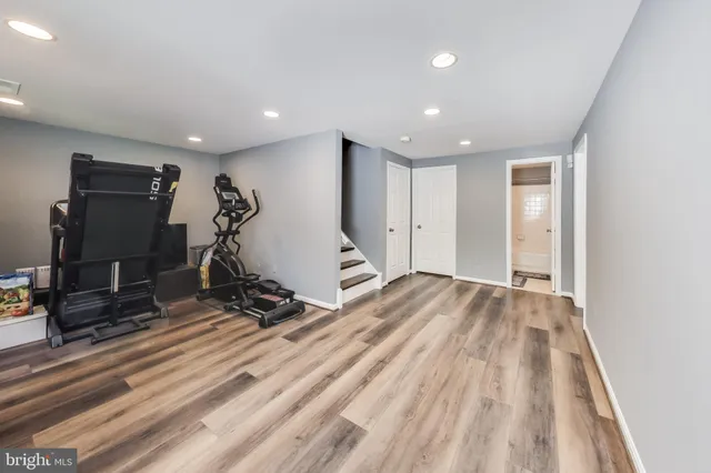a view of a room with gym equipment and a flat screen tv