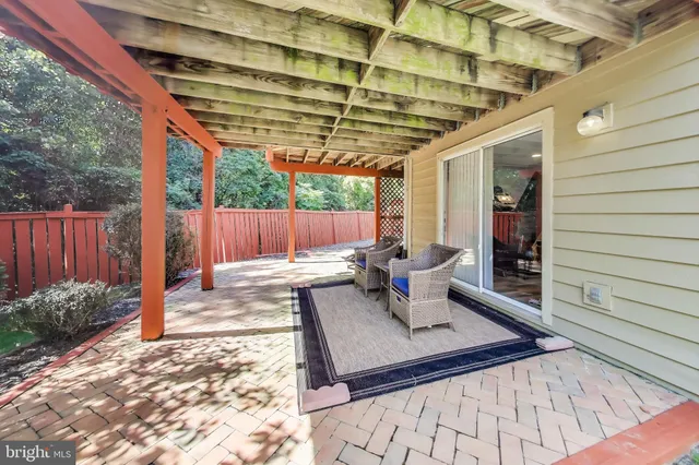 a view of deck with two chairs and wooden fence
