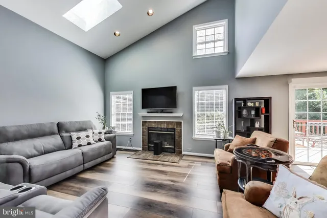 a living room with furniture a fireplace and a flat screen tv