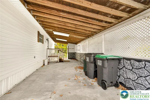 a view of staircase with white walls and a window