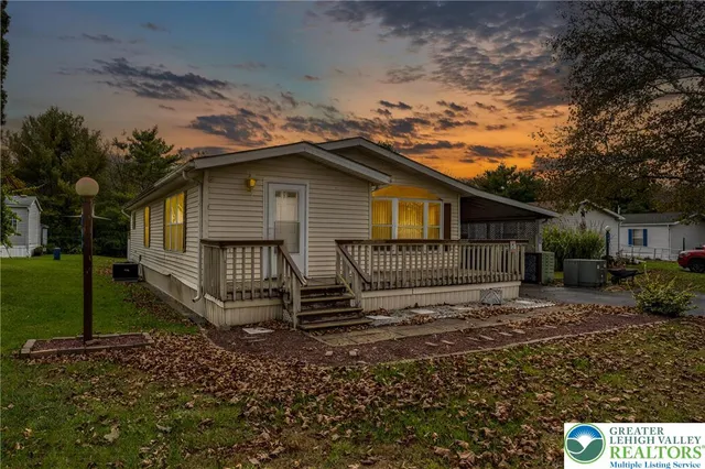 a house view with swimming pool and garden space