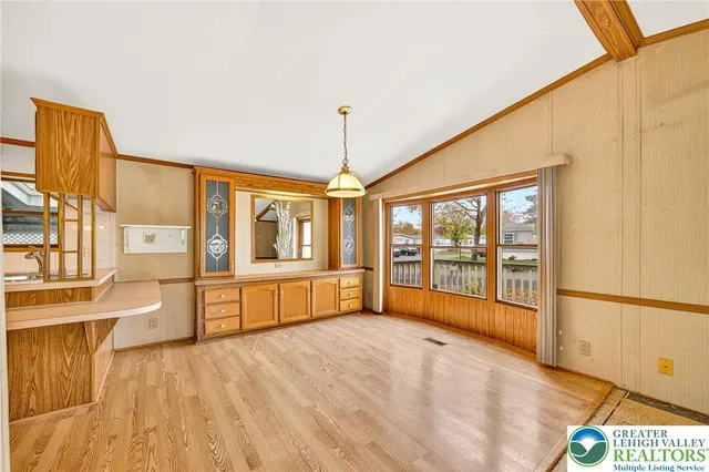 a large kitchen with stainless steel appliances granite countertop a stove and a large window