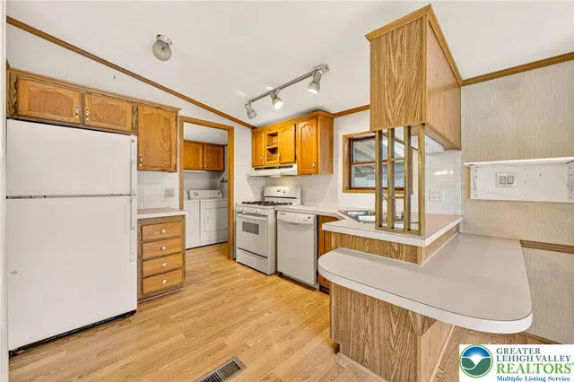 a view of a living room with furniture and fireplace
