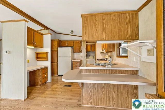 a kitchen with stainless steel appliances granite countertop a stove and a refrigerator
