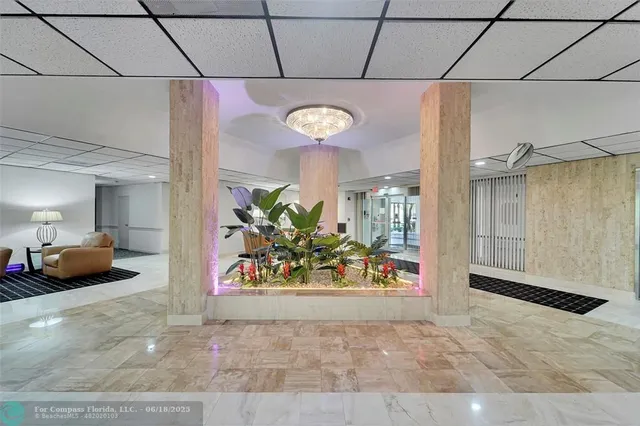 a view of a hallway with dining table and chairs