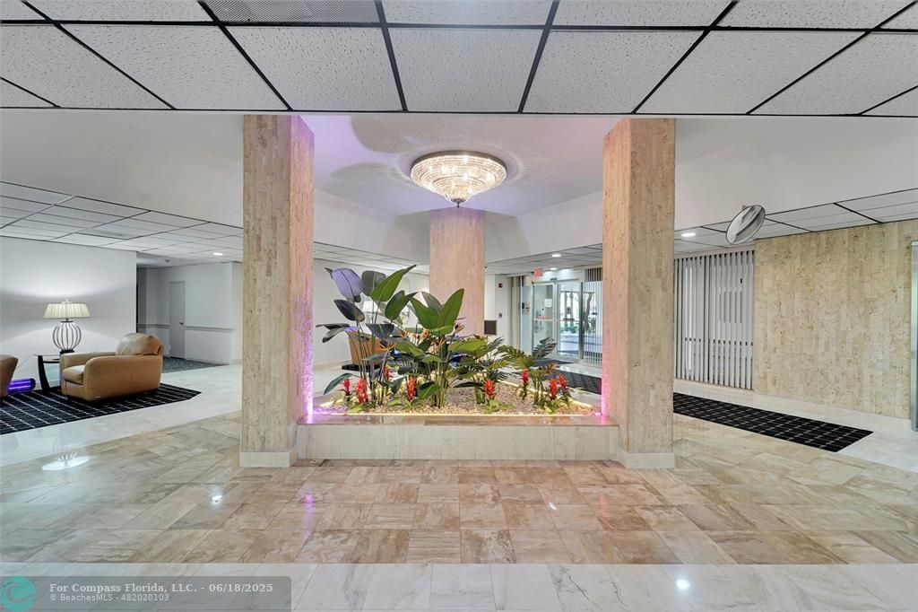 10777 West Sample Road, Unit 805 Coral Springs, FL 33065 - Photo 23 of 34 a view of a hallway with dining table and chairs