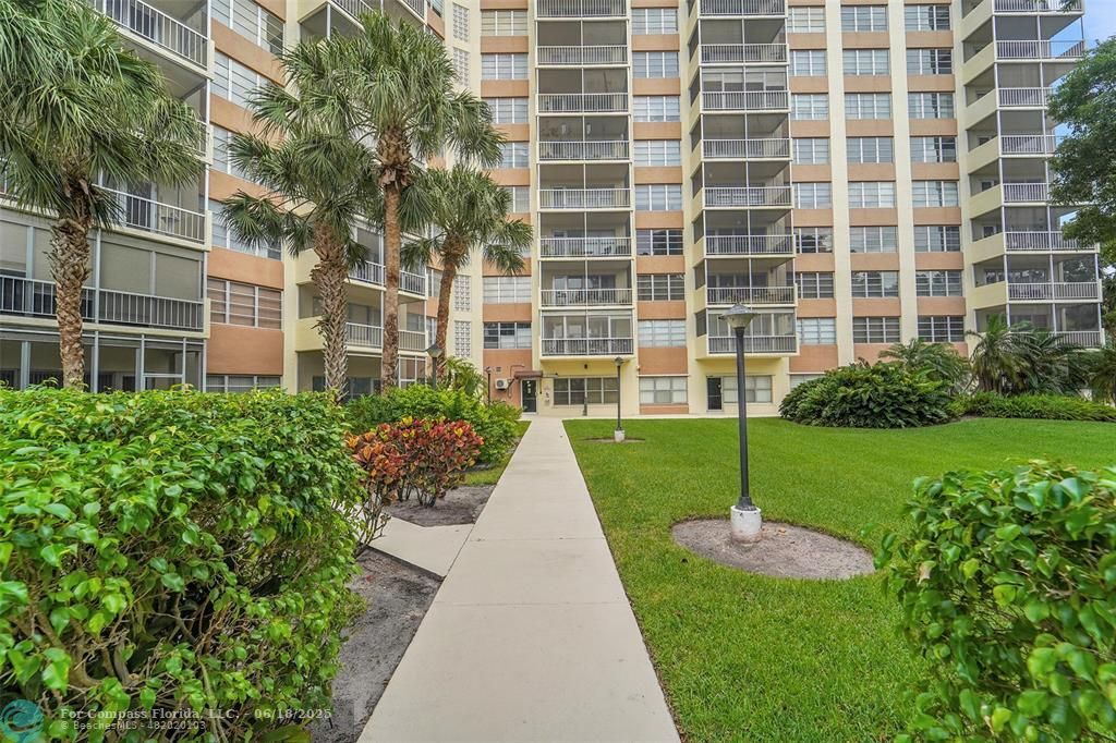 10777 West Sample Road, Unit 805 Coral Springs, FL 33065 - Photo 30 of 34 a view of a brick house with a yard