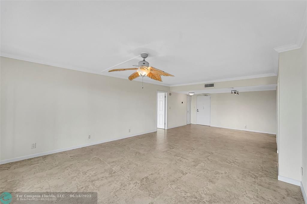 10777 West Sample Road, Unit 805 Coral Springs, FL 33065 - Photo 5 of 34 an empty room with a ceiling fan and window