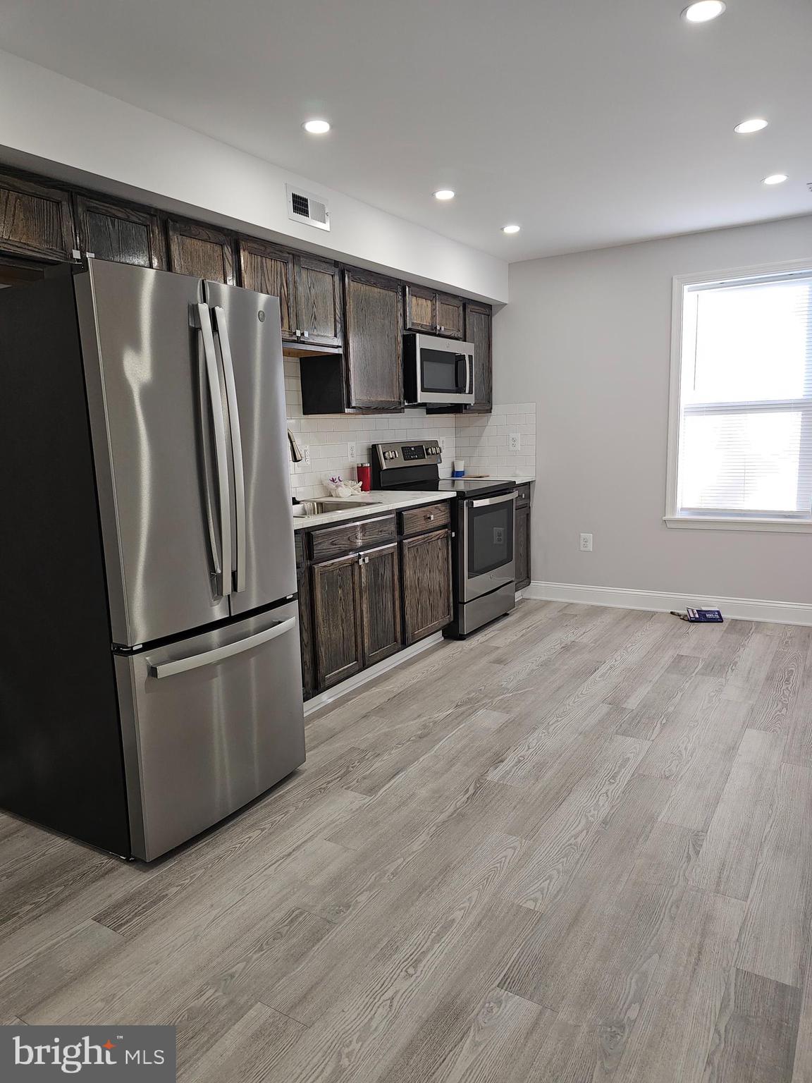 802 Allen Street Cambridge, MD 21613 - Photo 2 of 13 a kitchen with stainless steel appliances granite countertop a refrigerator and a stove top oven