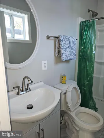 a bathroom with a toilet sink and mirror