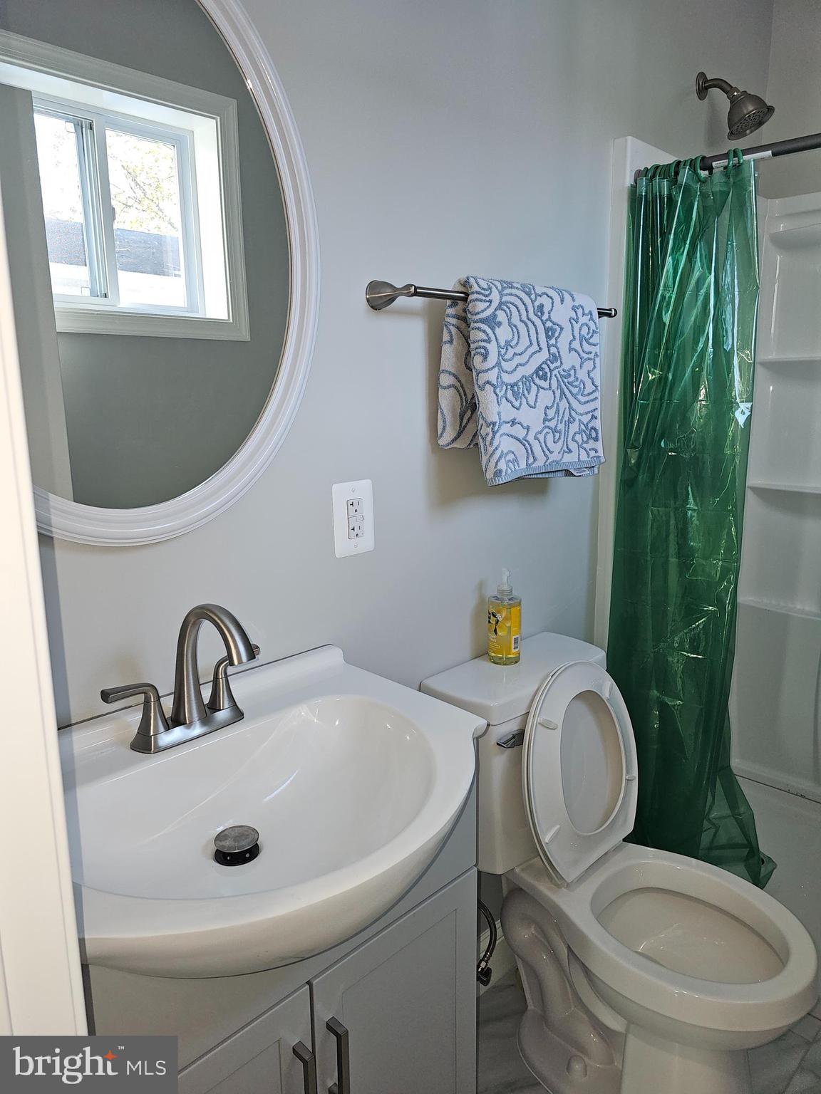 802 Allen Street Cambridge, MD 21613 - Photo 5 of 13 a bathroom with a toilet sink and mirror