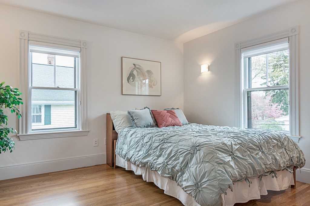 7 Raymond Street Lexington, MA 02421 - Photo 11 of 22 a bedroom with a bed and wooden floor