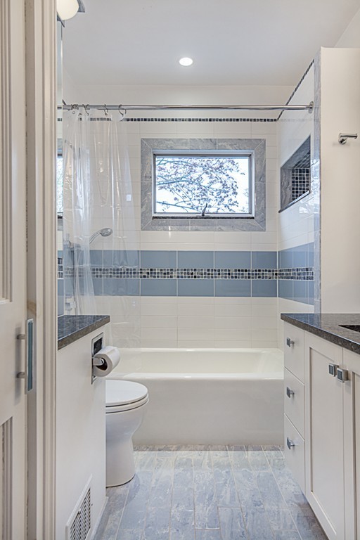 7 Raymond Street Lexington, MA 02421 - Photo 13 of 22 a bathroom with a large tub a toilet and a shower