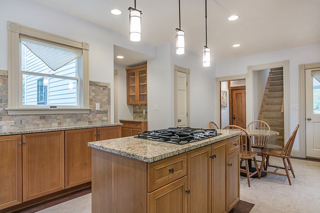 7 Raymond Street Lexington, MA 02421 - Photo 8 of 22 a kitchen that has a stove a table and chairs in it
