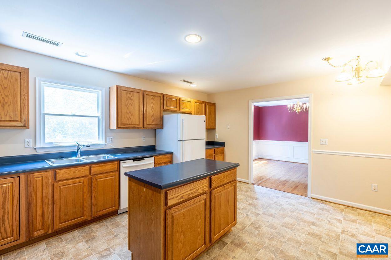 165 Rustling Oaks Way Ruckersville, VA 22968 - Photo 8 of 52 a kitchen with stainless steel appliances granite countertop a sink stove and cabinets