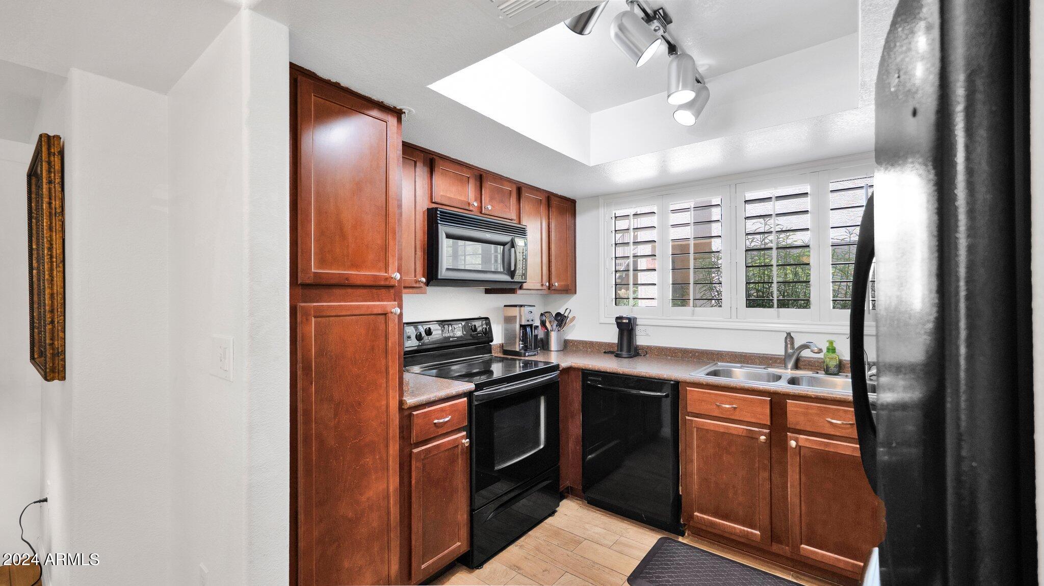 9990 North Scottsdale Road, Unit 1043 Paradise Valley, AZ 85253 - Photo 11 of 28 a kitchen with stainless steel appliances granite countertop a sink and stove top oven