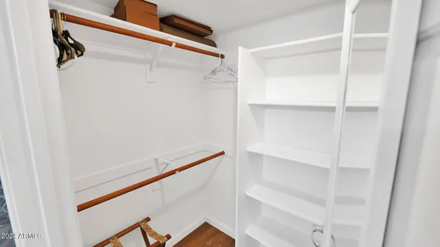 a view of walk in closet with empty racks