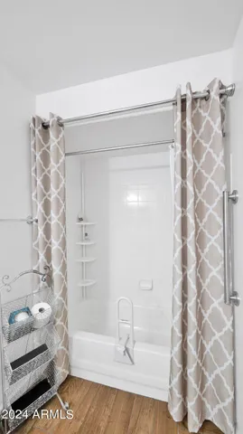 a bathroom with a bathtub and shower