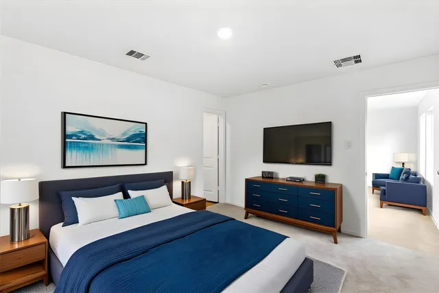 a bedroom with a bed and a flat screen television