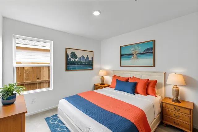 a bedroom with bed and a window