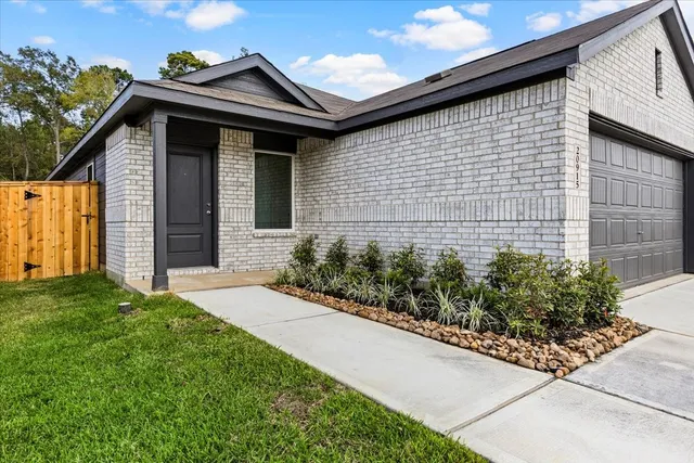a front view of a house with garden