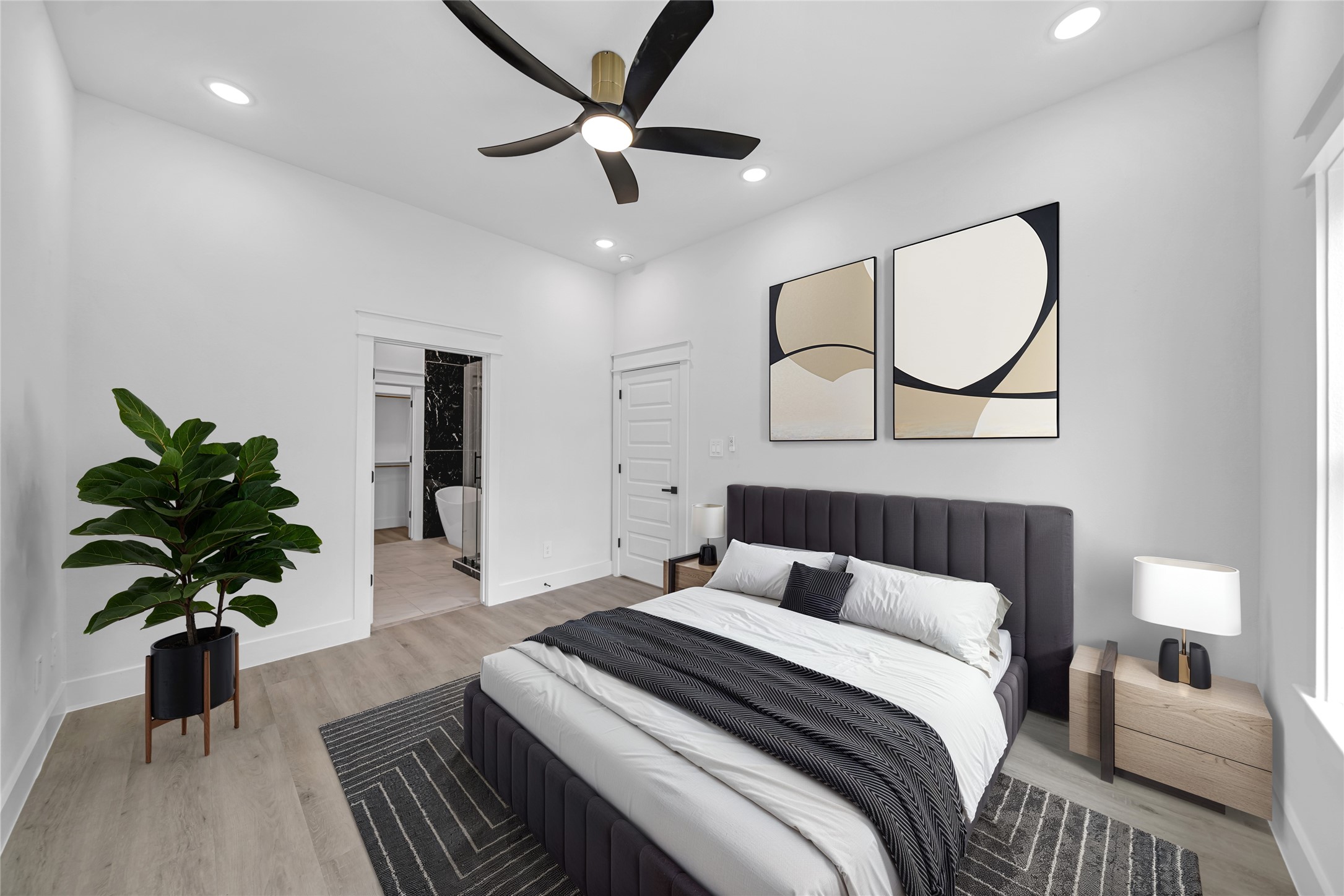 4834 Higgins Street, Unit B Houston, TX 77033 - Photo 10 of 34 a bedroom with a bed and a potted plant