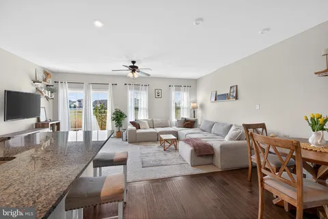 a living room with furniture wooden floor and a flat screen tv