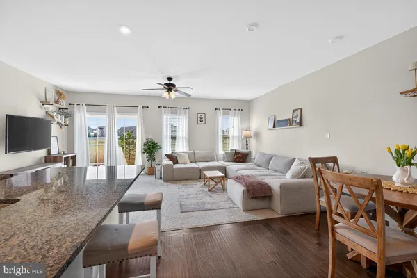 a living room with furniture wooden floor and a flat screen tv